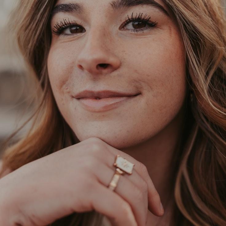 Kaveri Mehta, Lead Design Curator at CedarQuillHarbor, reviewing corporate floral arrangements